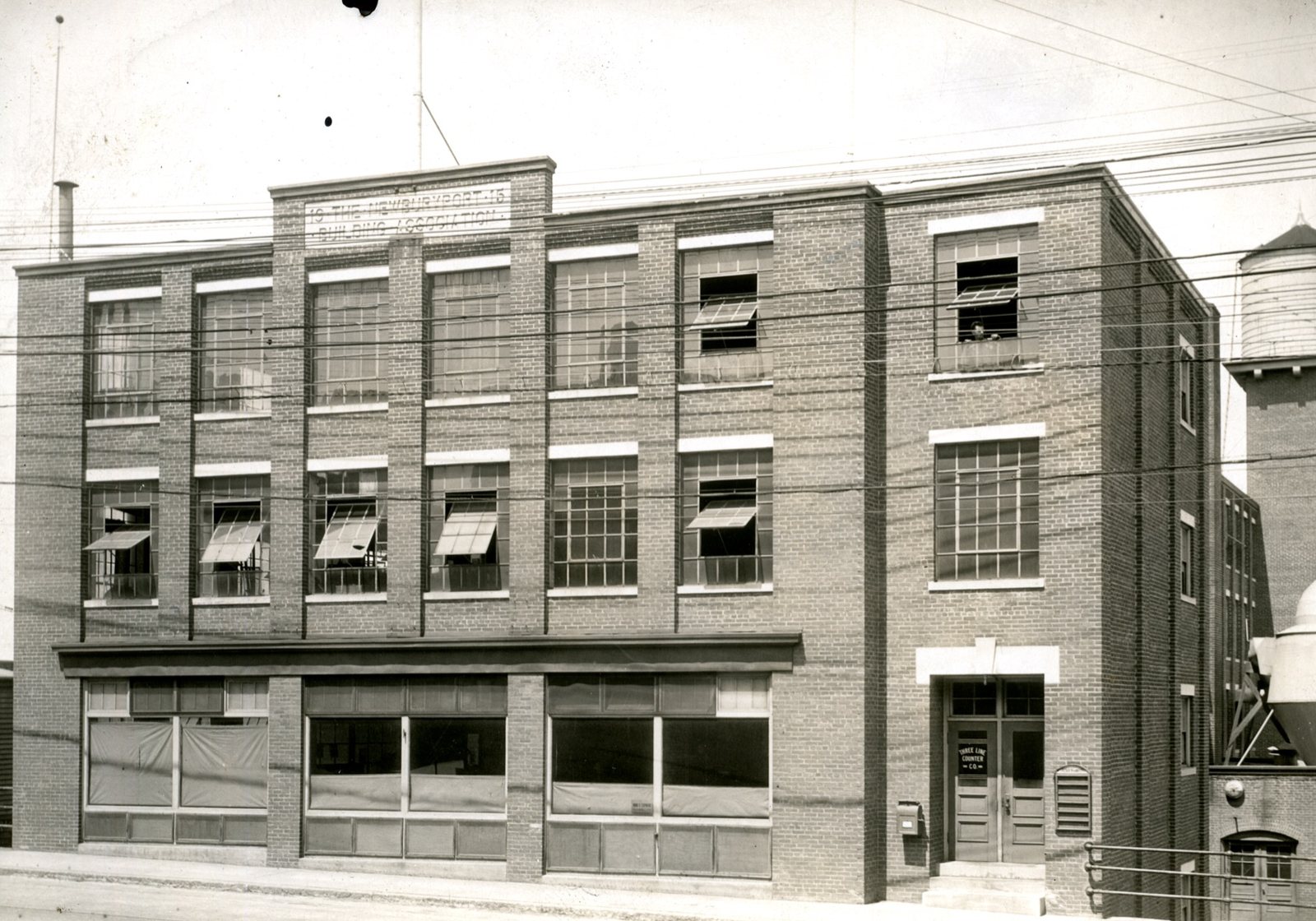 The factory in 1919 with Three Line Counter Co. on the door