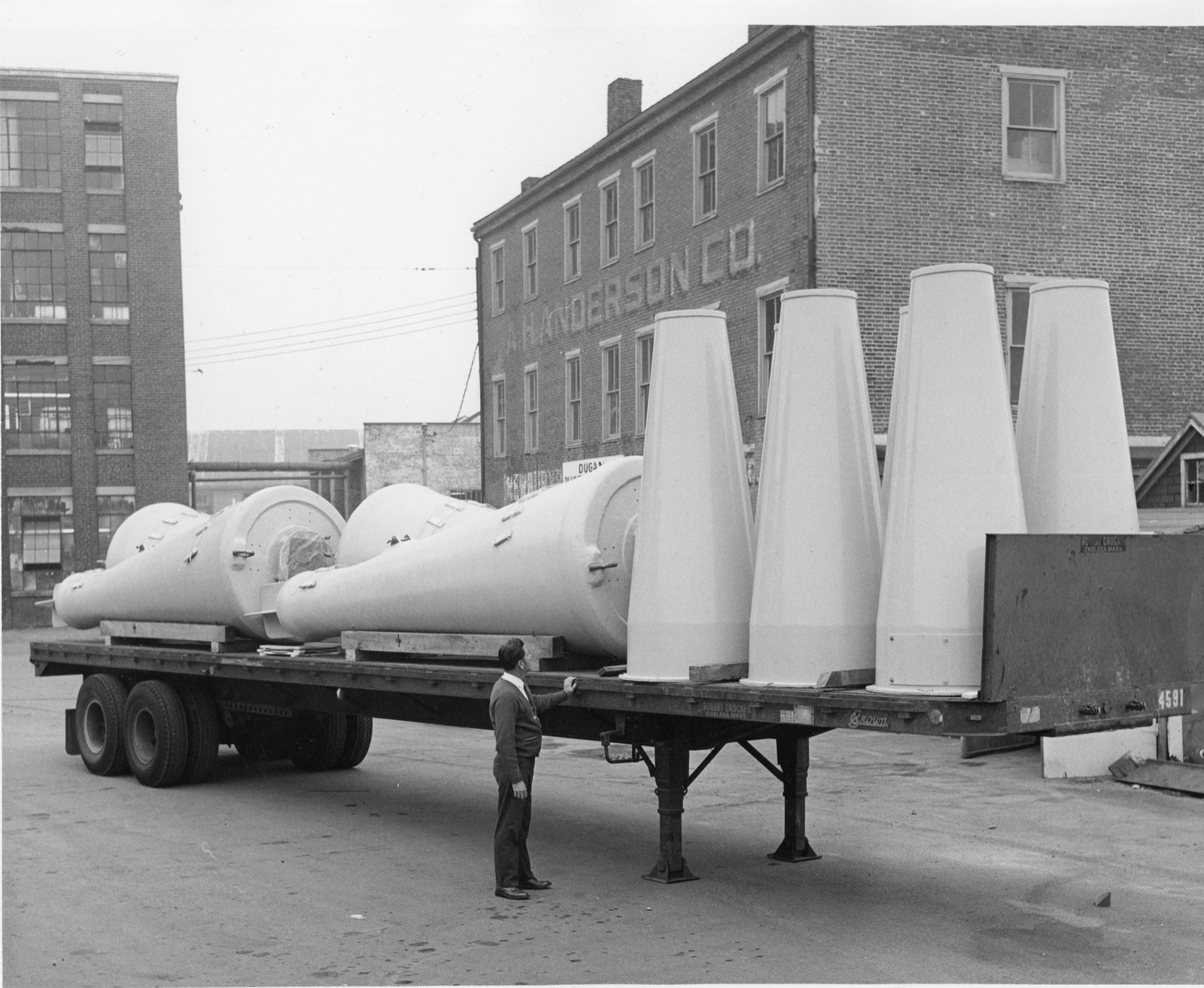 Coast Guard navigational buoys on a flatbed truck outside the building