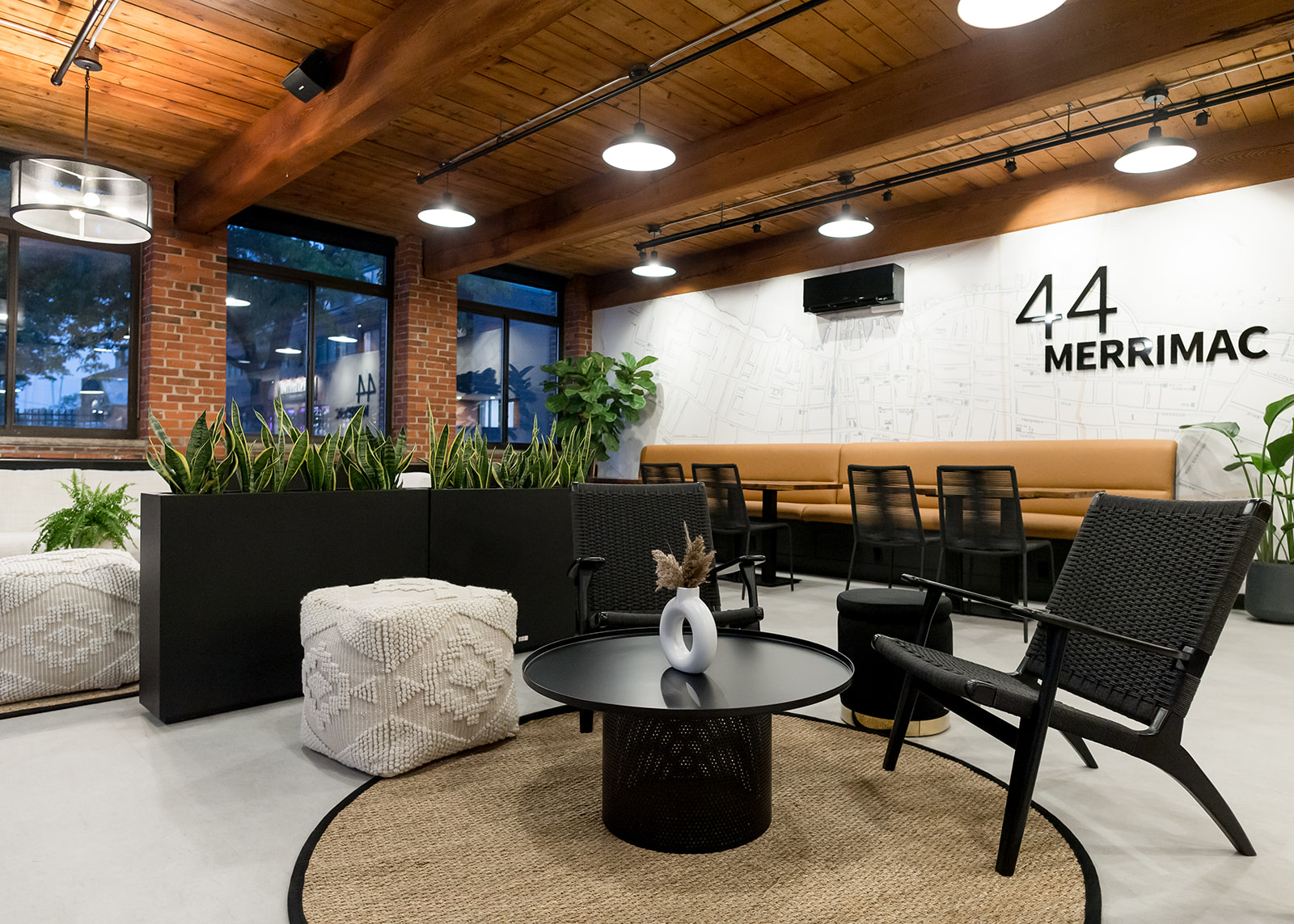Lounge seating with exposed brick and original windows