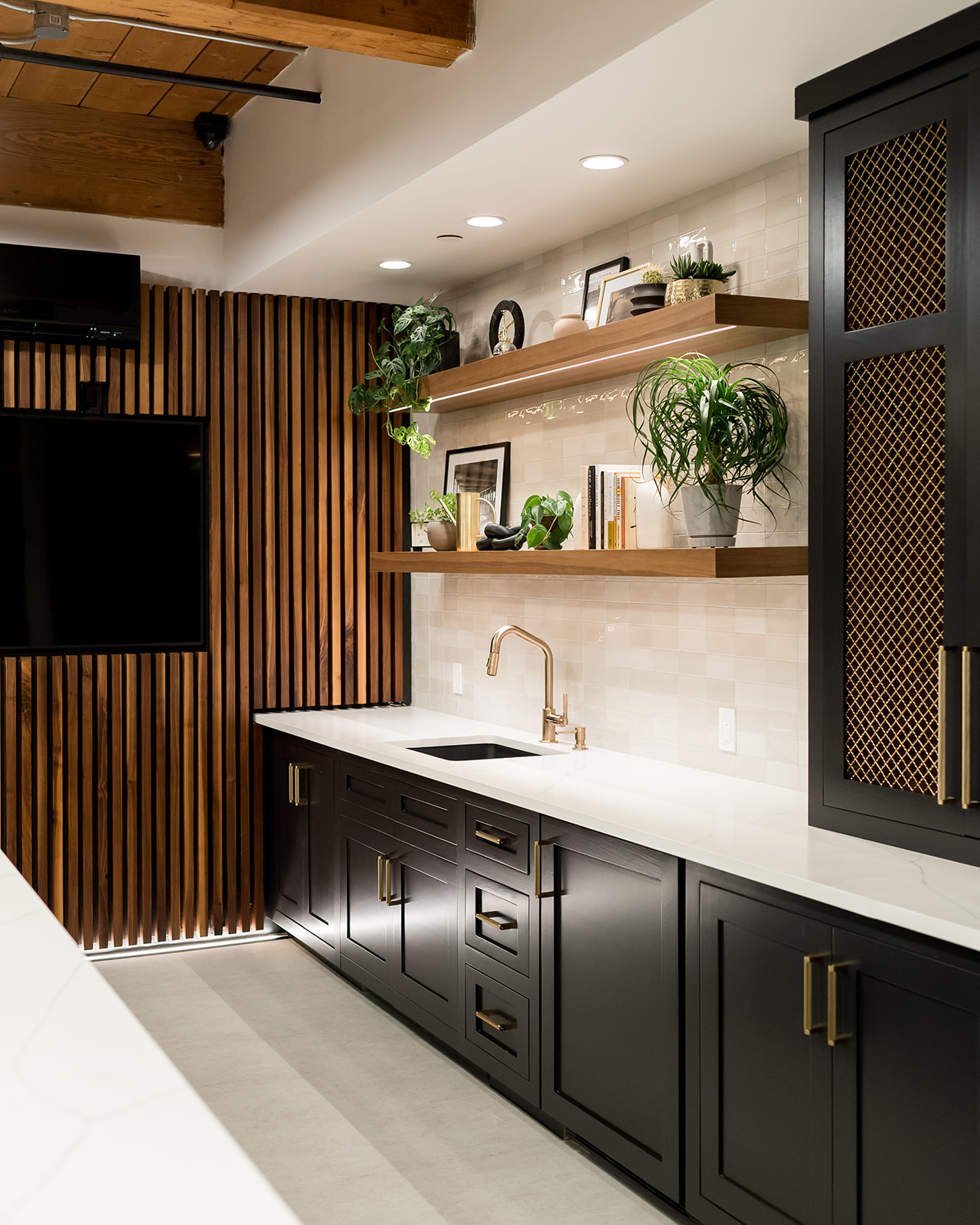 Lounge kitchen with floating shelves and brass fixtures