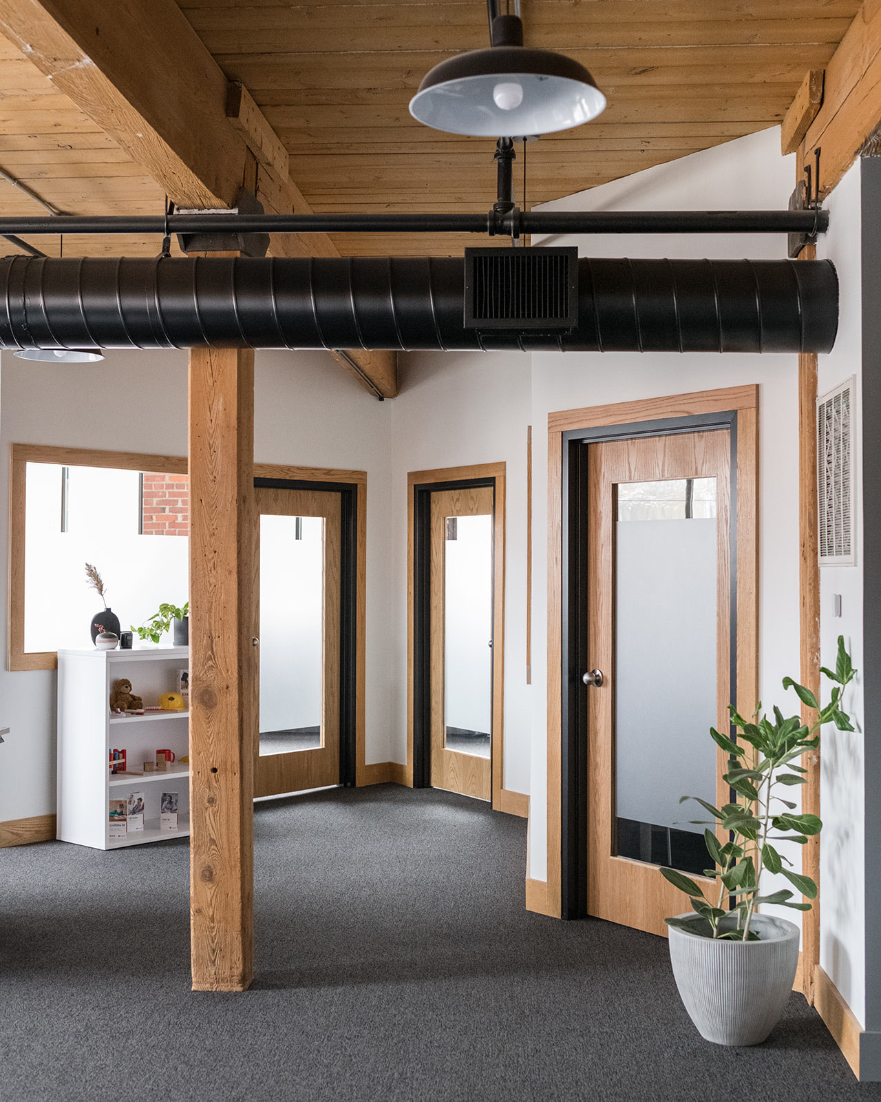 Private offices with glass-panel doors inside a team suite