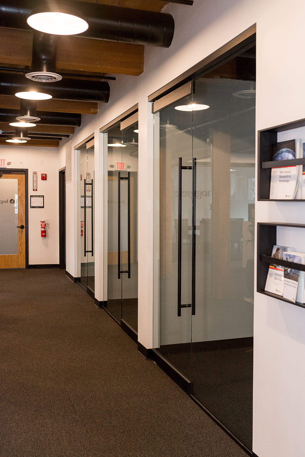 Glass-fronted offices along a suite corridor